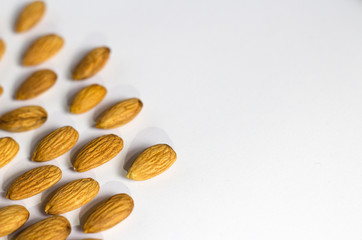 handful of almonds on white background