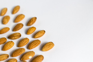 handful of almonds on white background