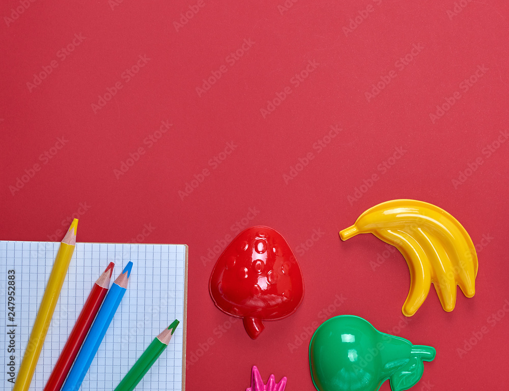 Poster notebook with empty white sheets and multicolored wooden pencils