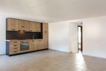 Modern wood kitchen in the apartment with white walls