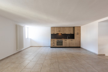 Modern wood kitchen in the apartment with white walls