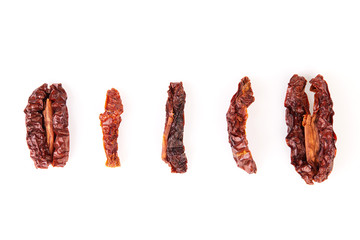 Sun dried tomatoes close up macro isolated on white background