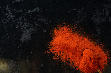 Red pepper powder on a black background