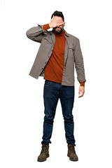 Fototapeta premium Full-length shot of Handsome man with beard covering eyes by hands. Do not want to see something on isolated white background