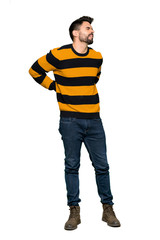 Naklejka premium Full-length shot of Handsome man with striped sweater suffering from backache for having made an effort on isolated white background