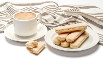 White ceramic cup of coffee with a savoiardi ladyfinger cookie on a plate