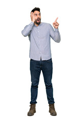 Full-length shot of Elegant man with shirt pointing up and surprised on isolated white background