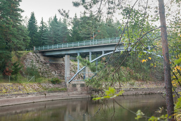 Fototapeta na wymiar Autumn landscape of bridge and Kymijoki river waters in Finland, Kymenlaakso, Kouvola, Myllykoski.