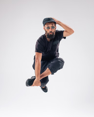 Hip hop dancer moving and jumping in photostudio