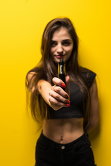 Young pretty brunette woman pointed on you vape electronic cigarette isolated on yellow background
