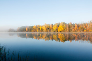 Beautiful autumn morning landscape of Kymijoki river waters in fog. Finland, Kymenlaakso, Kouvola.