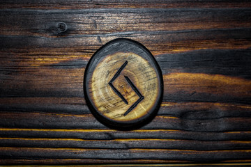 Rune Jera (Jeran, Jeraz) carved from wood on a wooden background - Elder Futhark