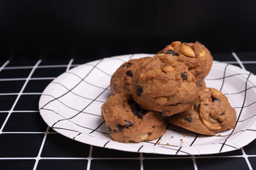 homemade Chocolate cookies on white line plate. closeup focus.