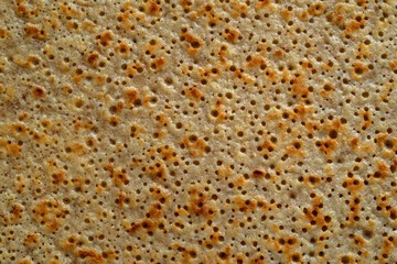 abstract spotty and porous organic texture of grain pastries closeup for a background or for...