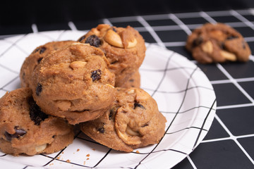 homemade Chocolate cookies on white line plate. closeup focus.