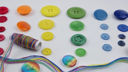 A set of buttons in the colors of the rainbow on a white background