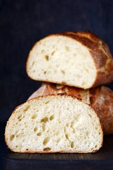 Fresh homemade bread on a gray-blue background, on whole wheat flour. French bread round shape. Bread baking. Unleavened bread