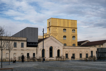 Fototapeta premium Milan, ITALY FEB 2019 - Fondzione Prada museum - golden yellow warm building in the new square Adriano Olivetti in the south of town.