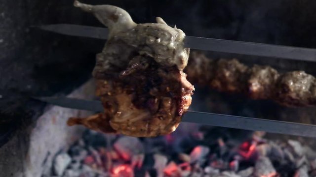 close up cooking barbecue quail bird with spinner on hot coal