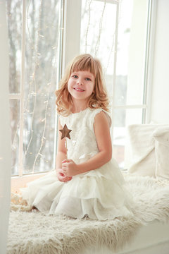 beautiful little girl with blue clases, blond hair and a sweet smile