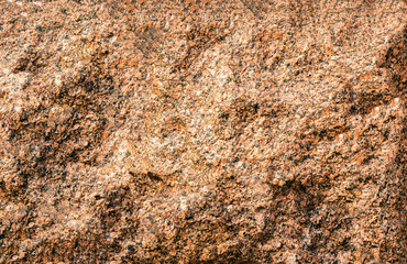 The texture of a stone fence made of granite. Background