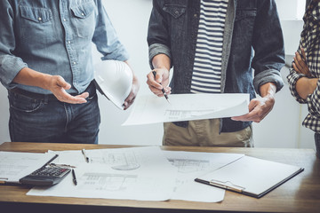 Construction and structure concept of Engineer or architect meeting for project working with partner and engineering tools on model building and blueprint in working site, contract for both companies