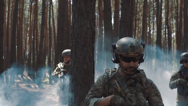 Soldiers patrol in forest