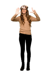 Obraz premium Full-length shot of Young woman with beret counting seven with fingers on isolated white background