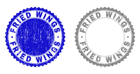 Grunge FRIED WINGS stamp seals isolated on a white background. Rosette seals with grunge texture in blue and gray colors. Vector rubber stamp imitation of FRIED WINGS title inside round rosette.
