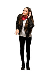 Full-length shot of Young woman with leather jacket listening to something by putting hand on the ear on isolated white background