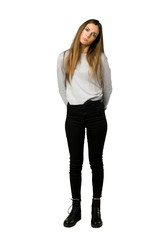 Full-length shot of young girl with sad and depressed expression on isolated white background