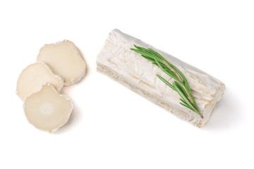 Stick of a goat cheese on paper on  the white background.