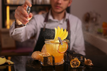 Fresh alcohol Penicillin cocktail with orange slice and ice cubes. Barmen making alcohol cocktail	