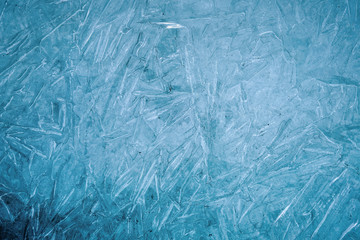 Ice natural textured blue background close up