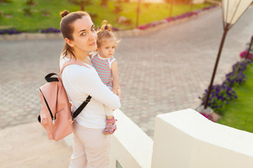 Mother hugging with her little daughter outdoor in nature on sunny day Positive human emotions, feelings, emotions.