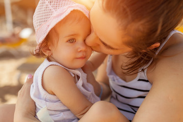 Mother hugging with her little daughter outdoor in nature on sunny day Positive human emotions, feelings, emotions.