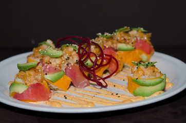 Sushi rolls in white plate and dark background