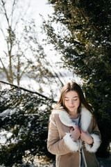 Young Beautiful girl  Smiling and posing Outdoors in Snowy Winter
