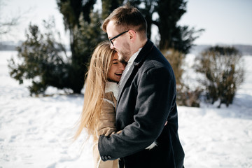 Young Beautiful Couple Taking Fun and Smiling Outdoors in Snowy Winter