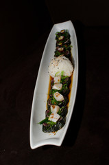 Sushi rolls in white plate and dark background