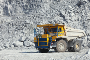 Large mining truck in a limestone quarry closeup. Mining industry.