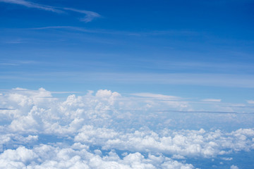Top view on plane of Blue sky and white puffy clouds.