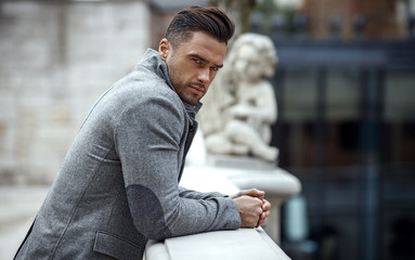 Obraz premium Portrait of handsome man in gray stylish jacket