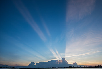 Sunset with light streaks and half of sky lit by setting sun