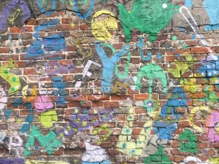 Graffiti on the brick wall. Urban street art background.