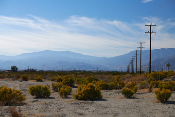 Fototapeta na wymiar Wooden electricity poles into the distance along the roads in California