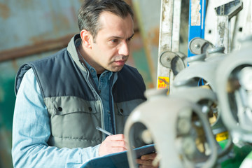 businessman with clipboard at warehouse