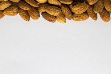 Frame with white background from handful of almonds, the nuts
