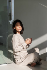 Beautiful young woman drinking coffee