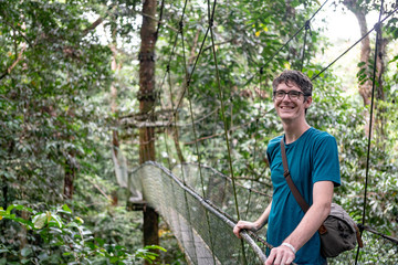 Young Handsome Male on Jungle Canopy Sky Walk Bridge in Mulu National Park, Borneo Malaysia